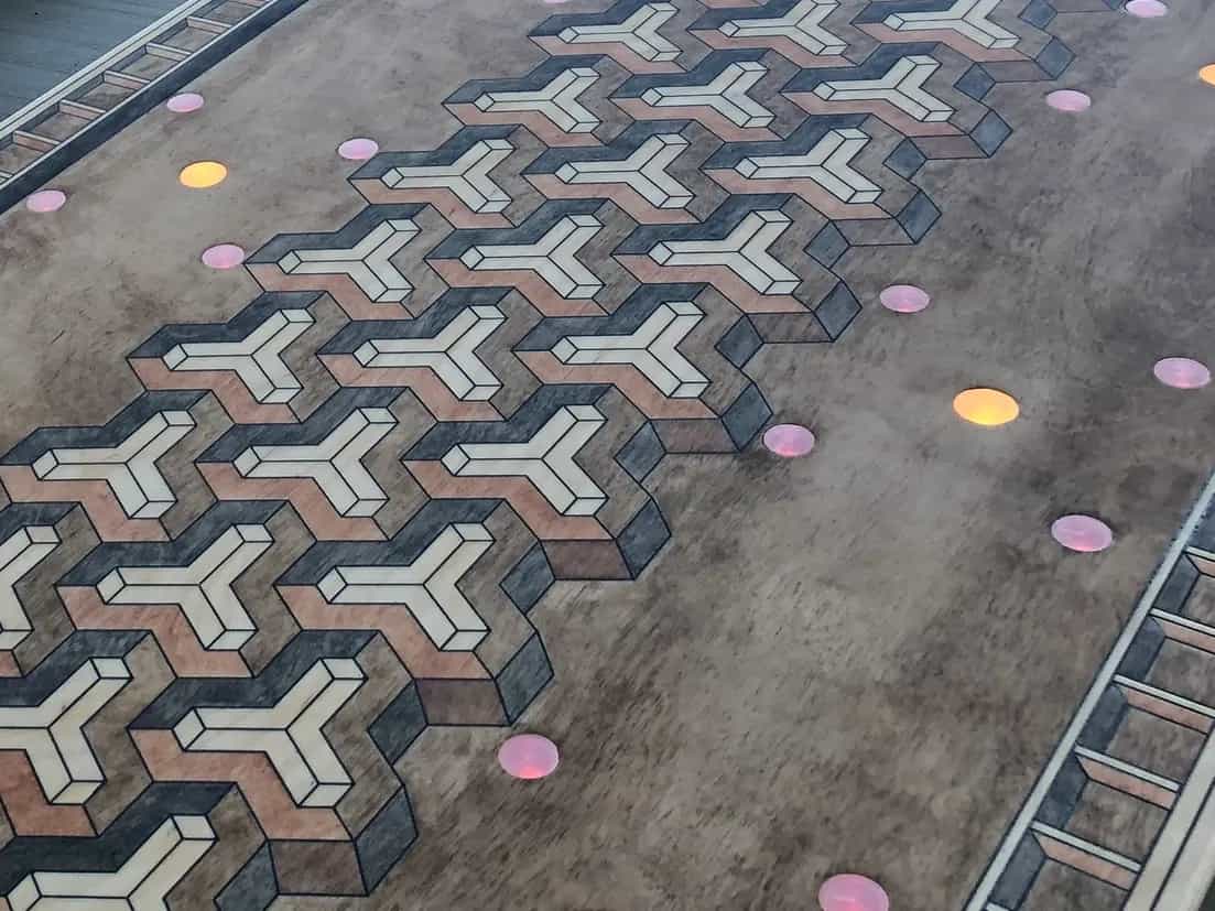 Detailed shot of a YoreBoard cornhole board highlighting its unique hand-stained 3D optical illusion design, emphasizing the board's craftsmanship and modern features.