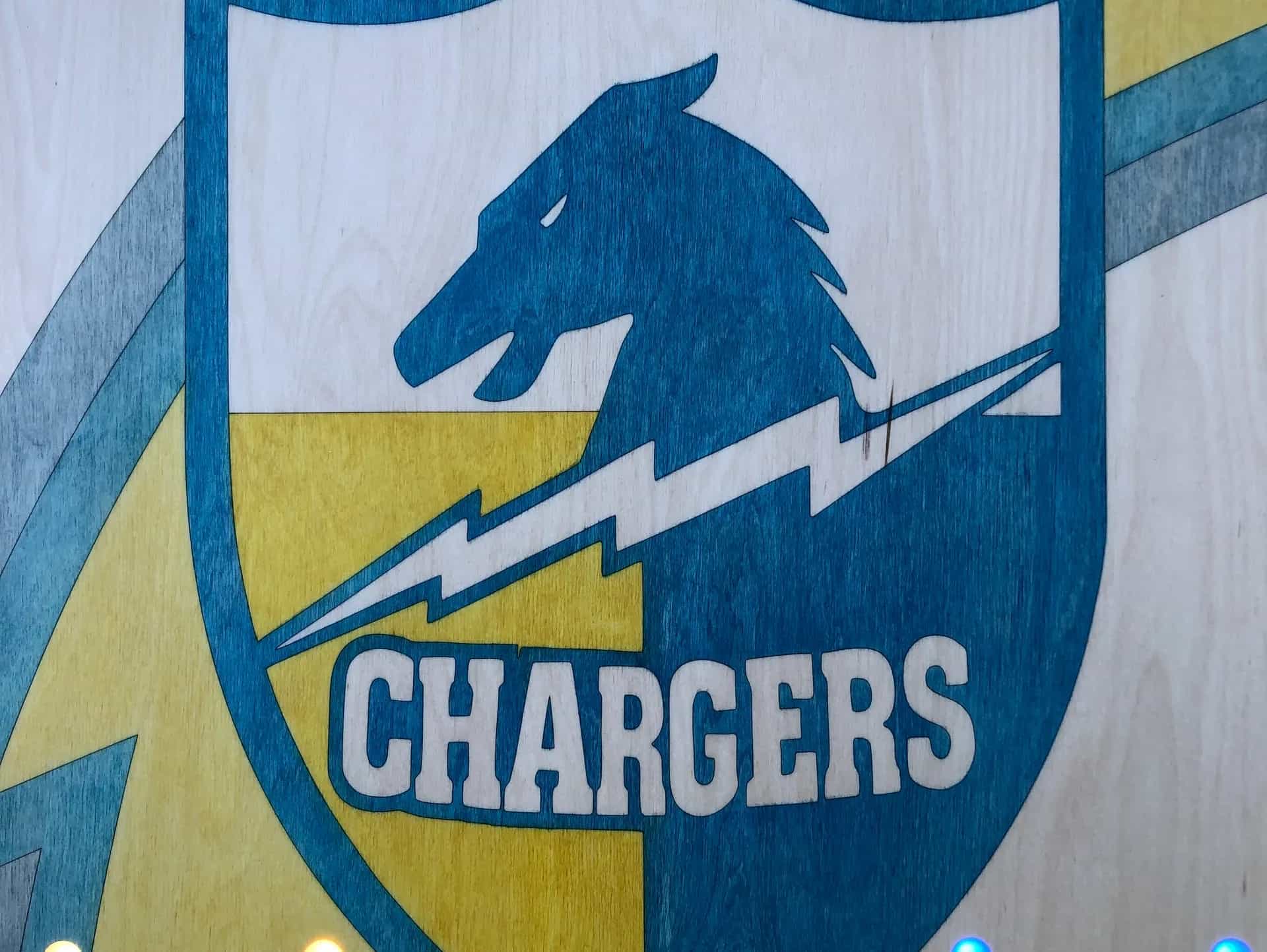 YoreBoard cornhole board surface showing Chargers team emblem.