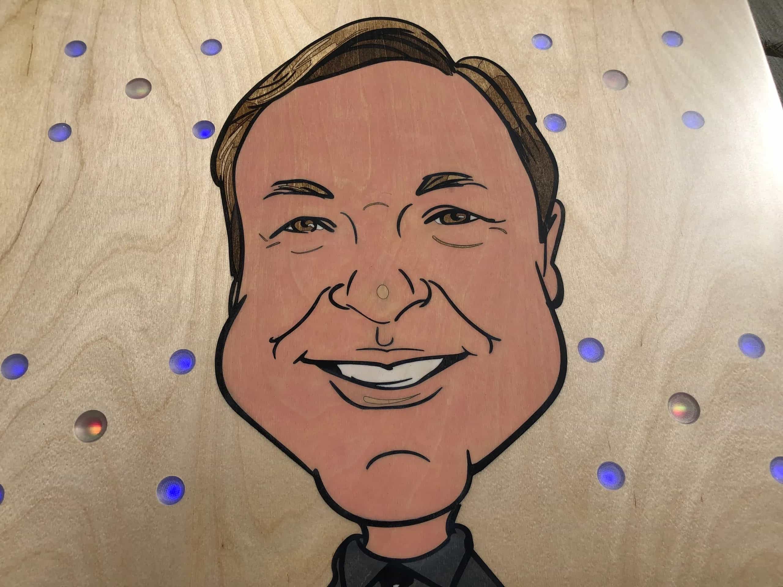 Detailed shot of a YoreBoard cornhole board highlighting its custom hand-stained caricature artwork, emphasizing personalized detail.