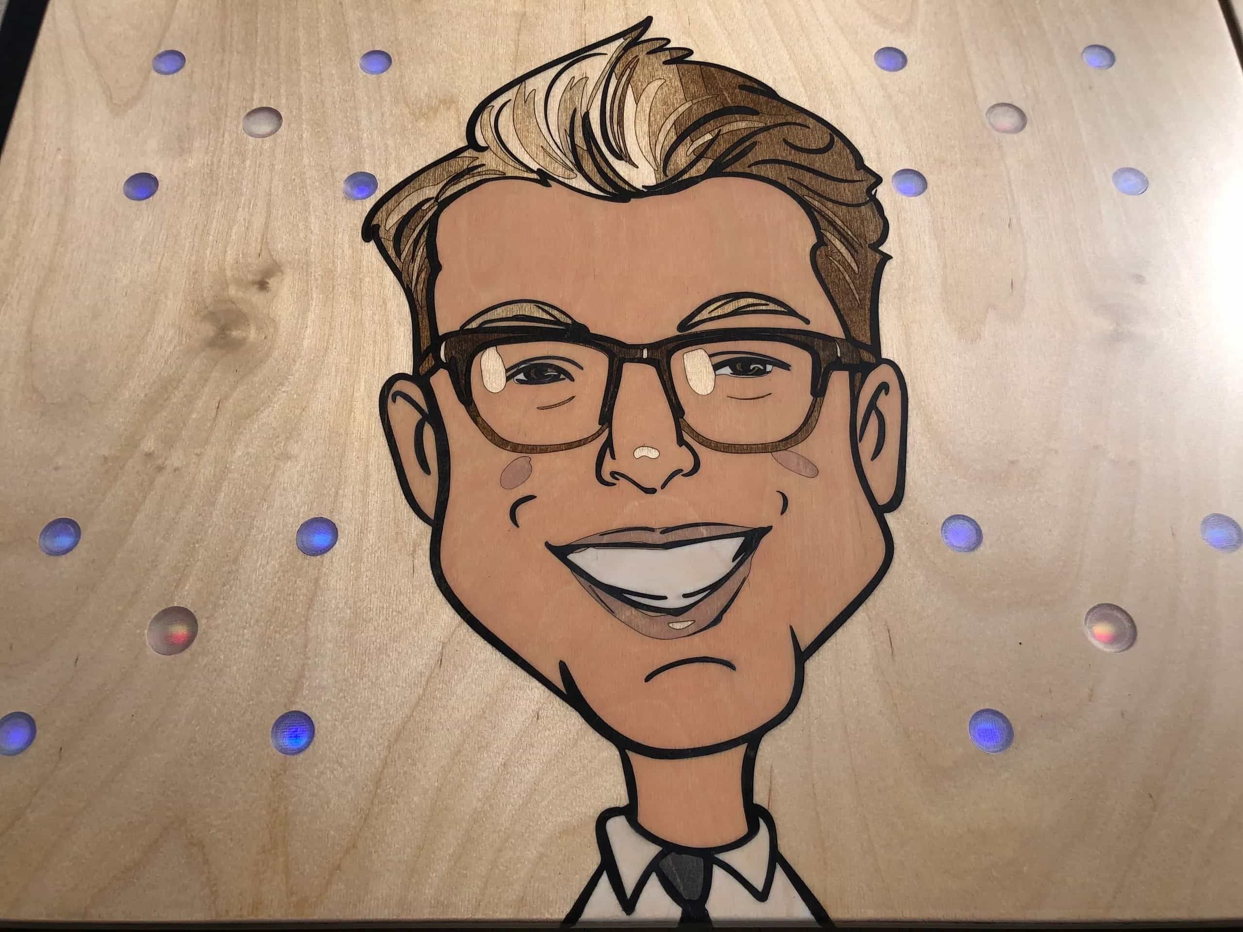 Close-up of a YoreBoard cornhole board highlighting its custom hand-stained caricature artwork, emphasizing personalization.