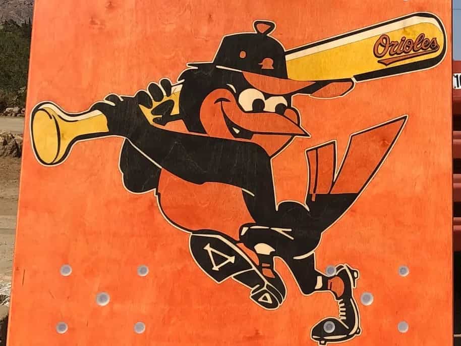 Detailed shot of a YoreBoard cornhole board highlighting its custom hand-stained Baltimore Orioles baseball team mascot design.