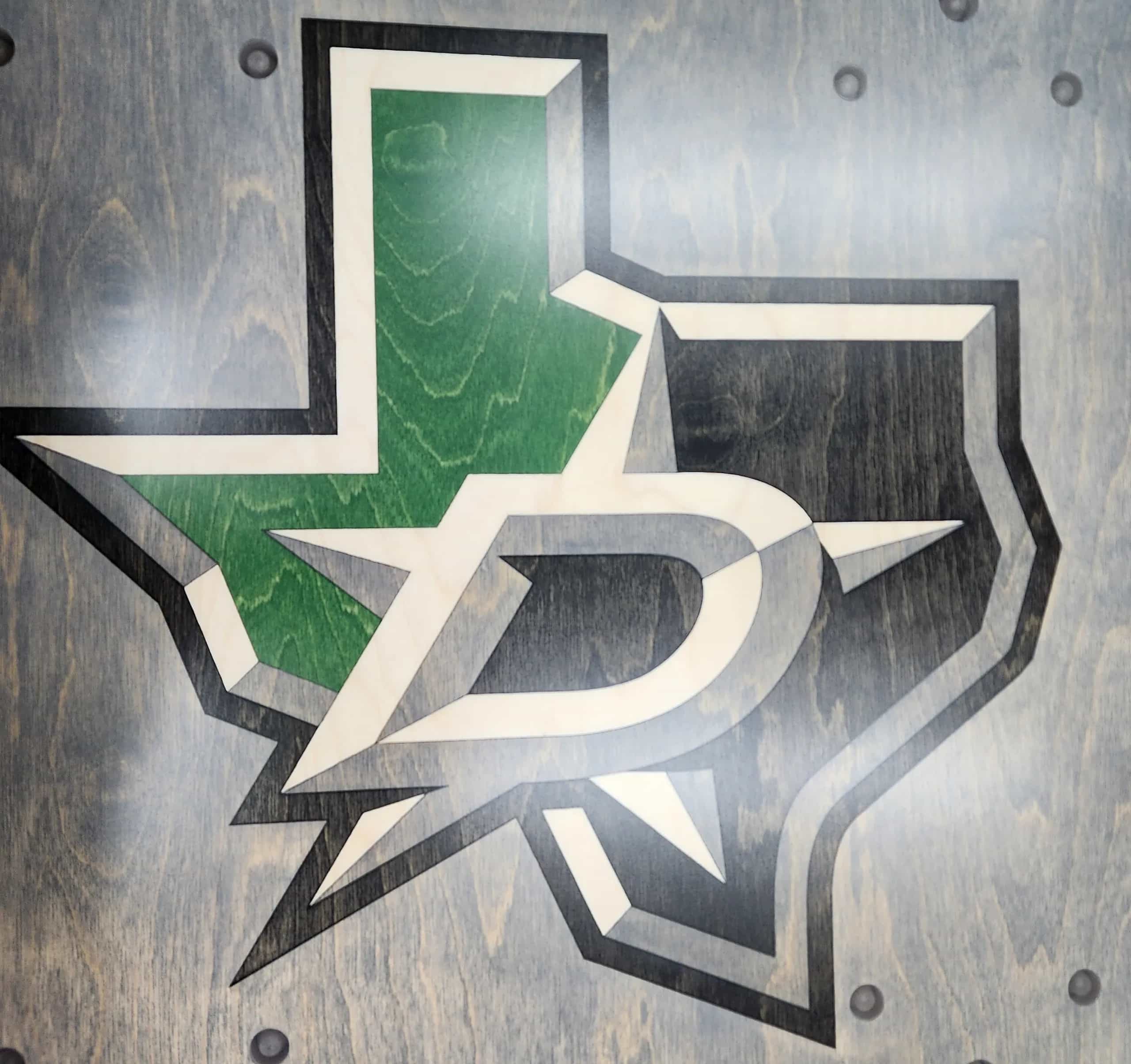 Close-up of a YoreBoard cornhole board with a hand-stained Dallas Stars logo.