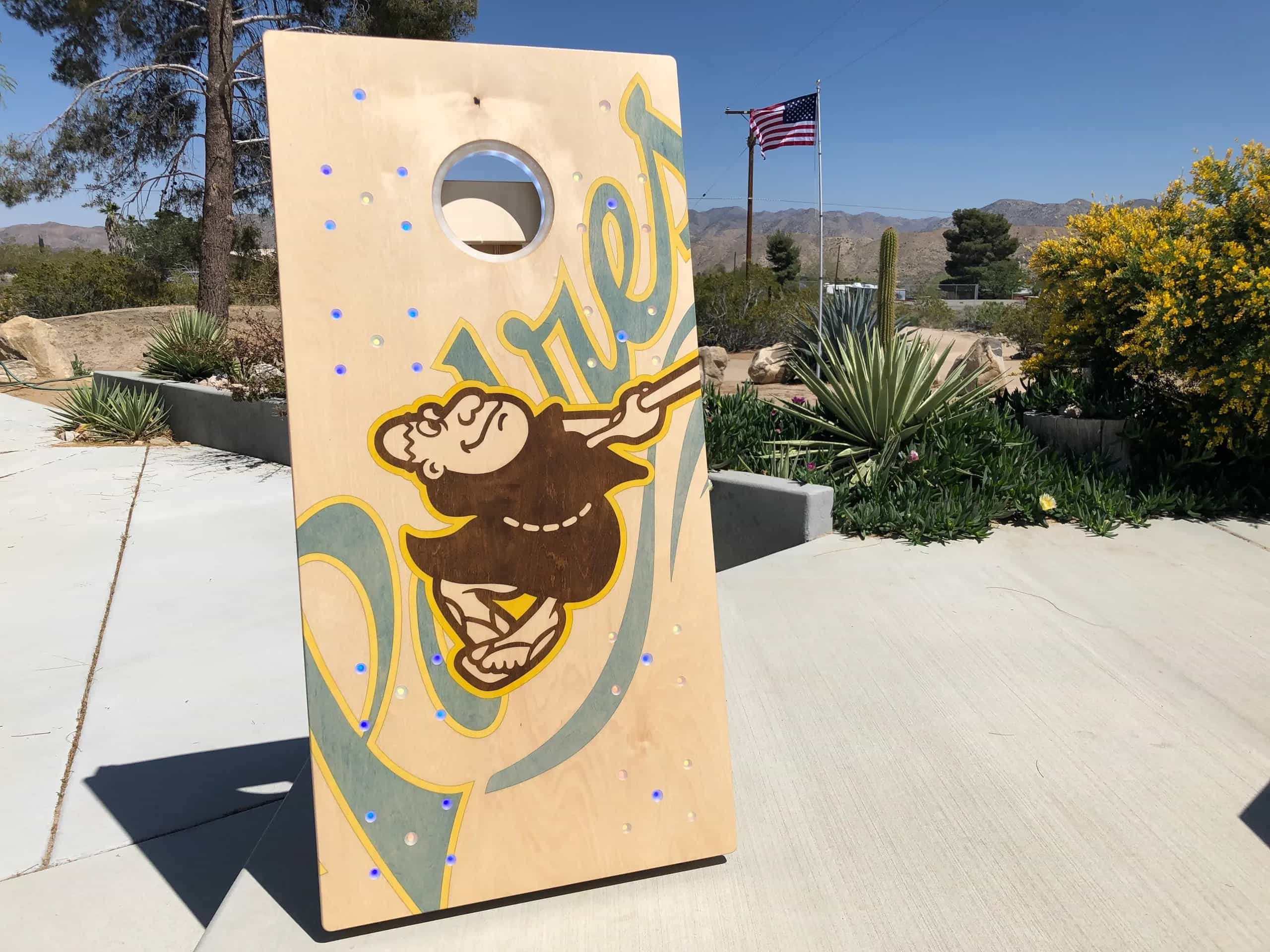 A YoreBoard cornhole board showcasing a detailed hand-stained San Diego Padres baseball team graphic, perfect for game day or fan display.