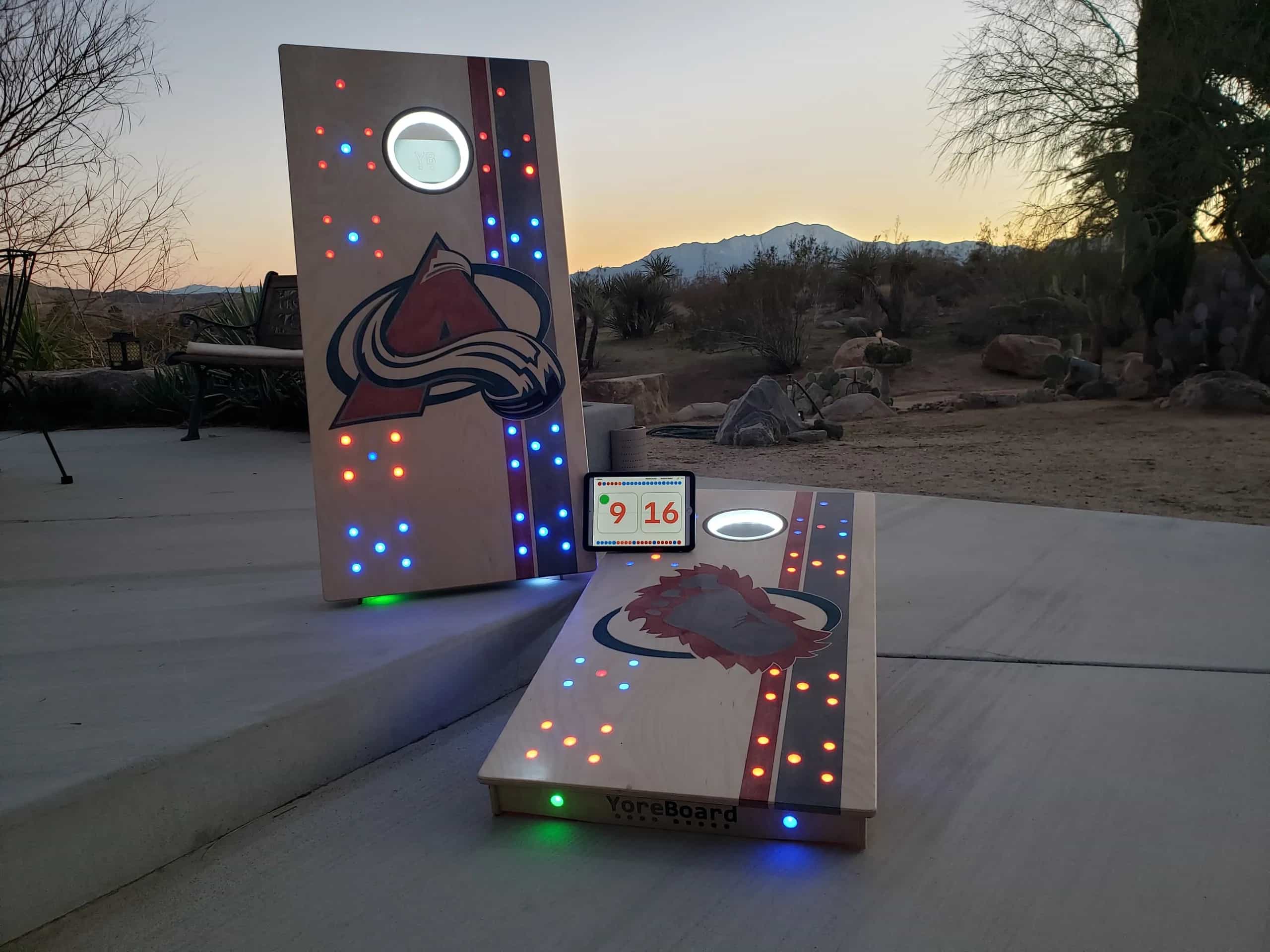 Personalized YoreBoard cornhole boards with Colorado Avalanche graphics, bright Scoring LEDs, and an active digital scoreboard for team-themed games.