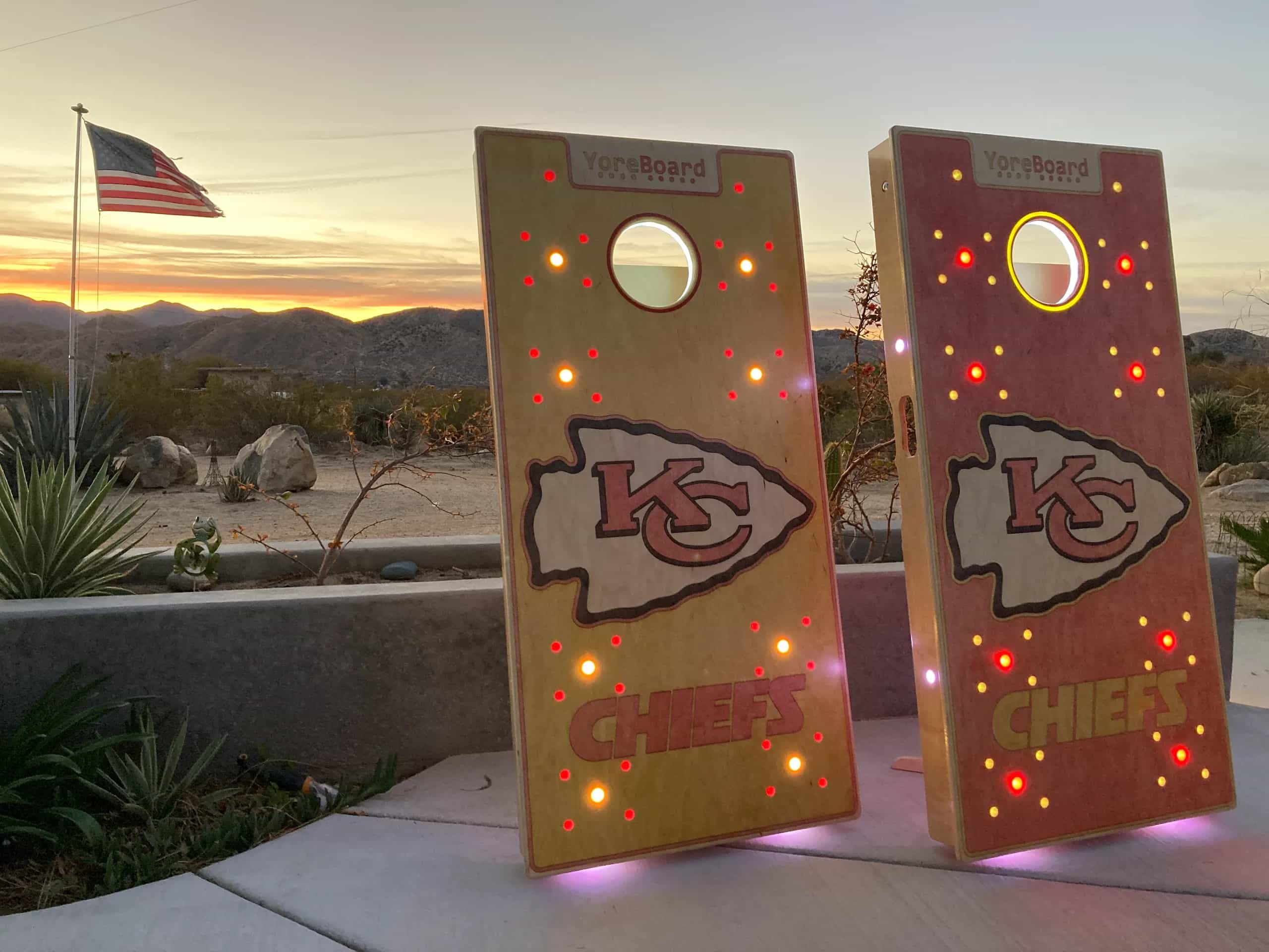 Personalized YoreBoard cornhole boards with Kansas City Chiefs branding, integrated glowing Scoring LEDs, and an active digital scoreboard for football fans.
