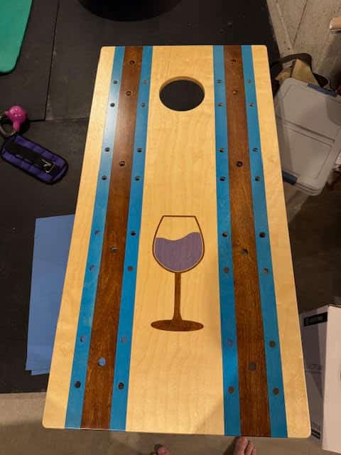Customer stained corhole deck with a wine glass design.  We make the stencil, you do the staining.