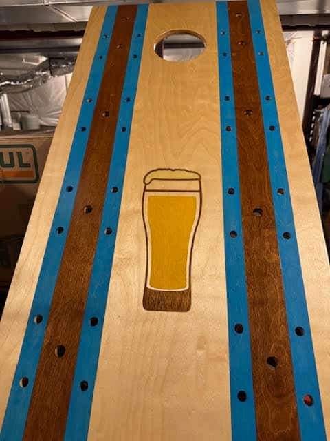 Customer stained corhole deck with a beer glass design.  We make the stencil, you do the staining.