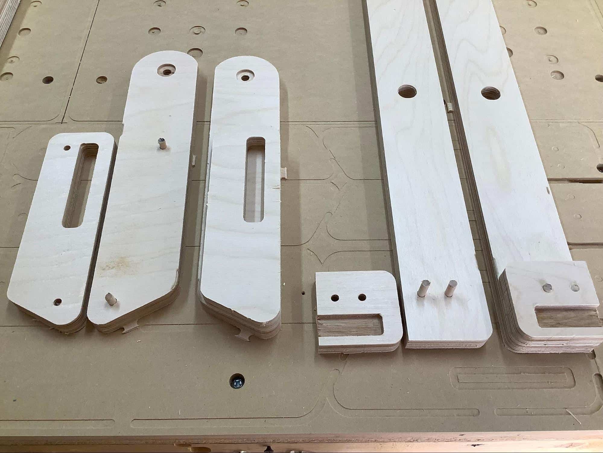 Image showing the dowels ready for installation for the leg and foot beef components of a cornhole board.