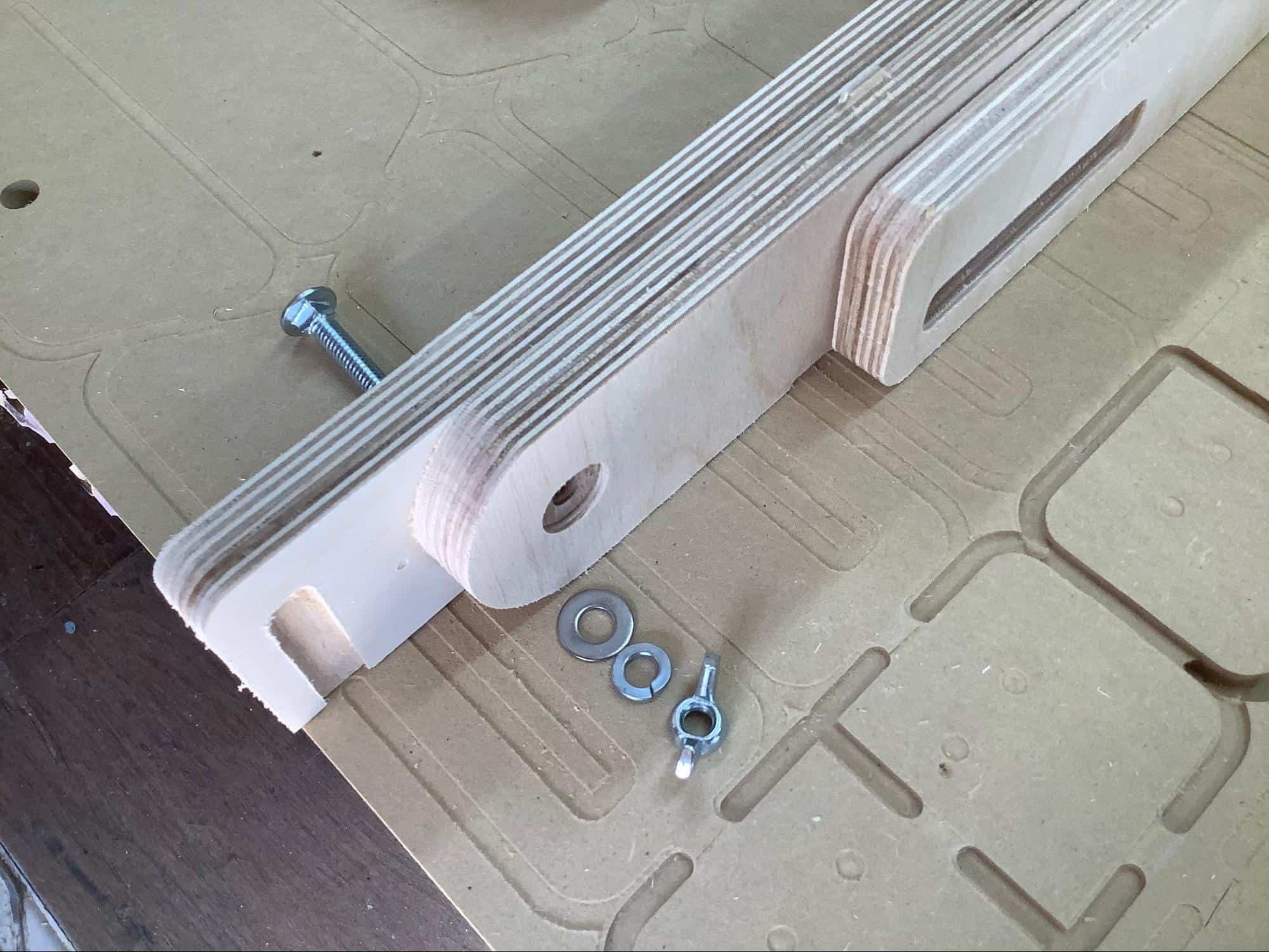 Image showing the proper order for installing the hardware for the legs on a YoreBoard cornhole board.