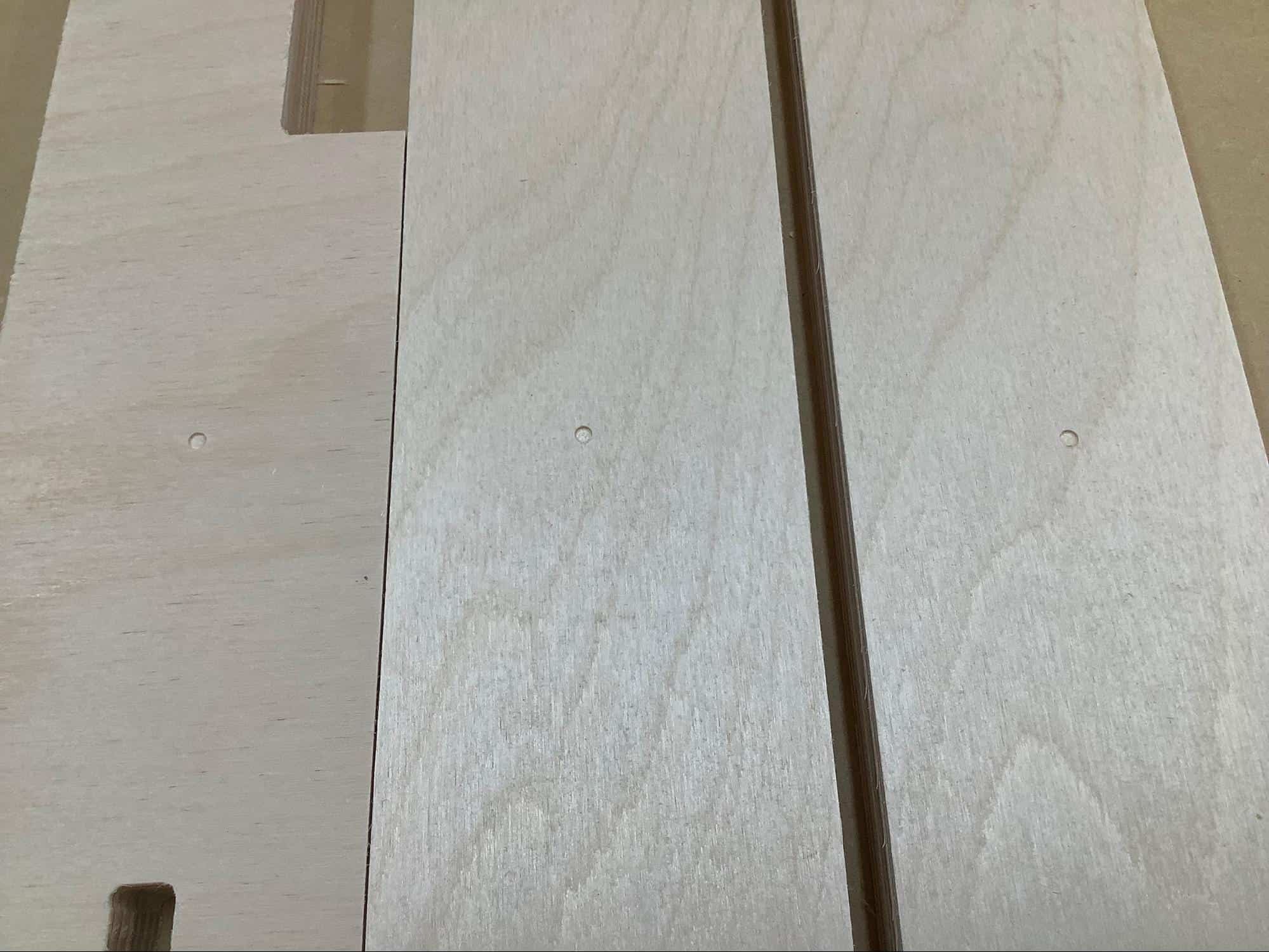 Image of pocket hole indicators on a YoreBoard cornhole board.
