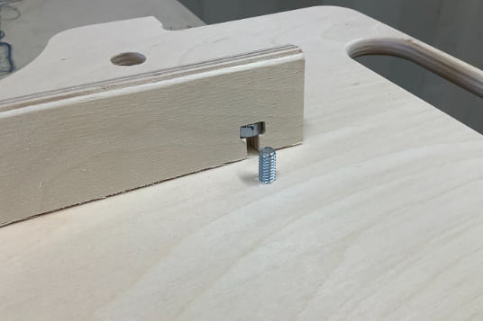 Image of how to fasten YoreBoard score tower spine with a nut and a bolt.