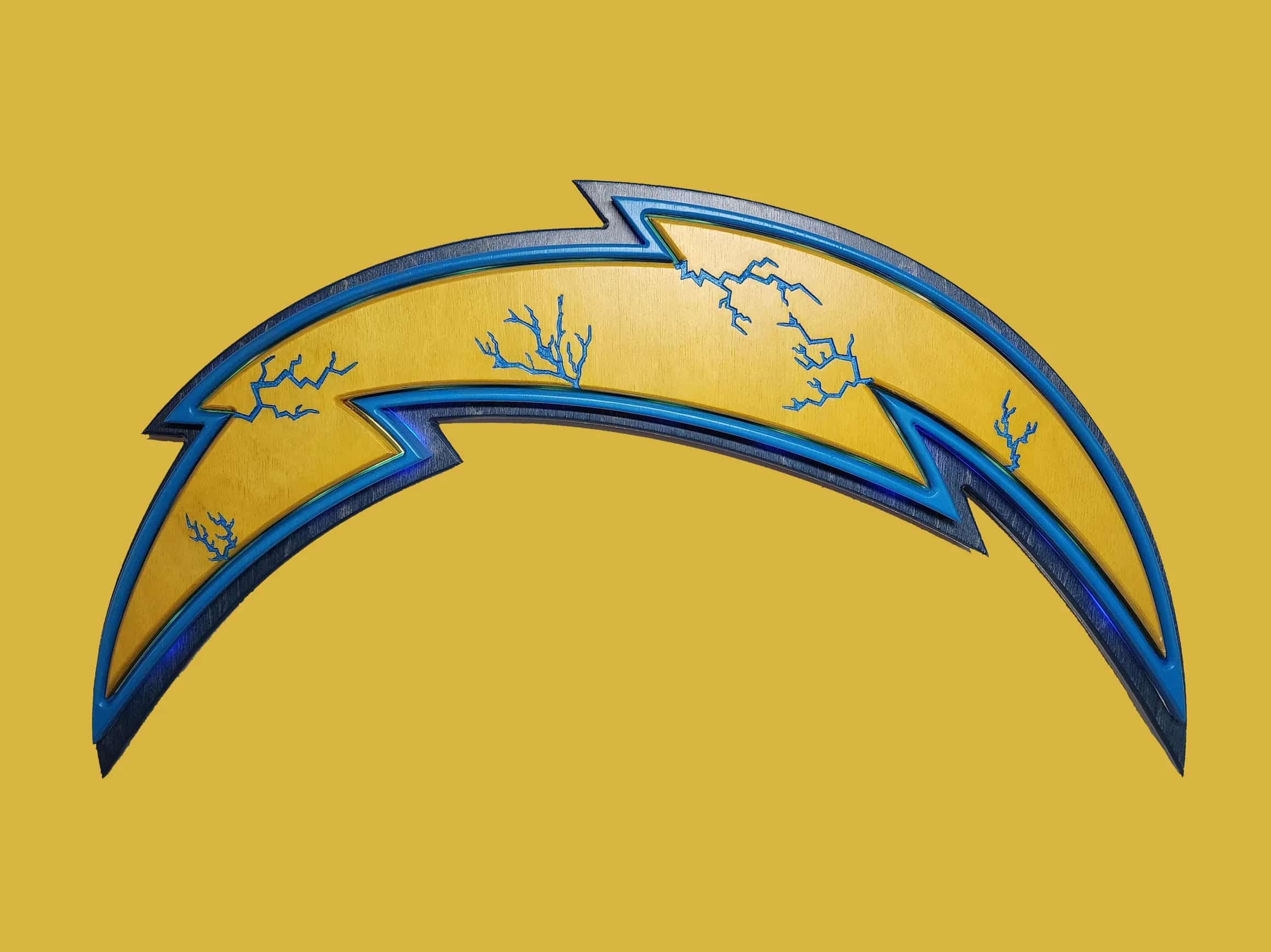 Custom-made, multi-layered Los Angeles Chargers logo, depicting the iconic lightning bolt in gold with intricate blue lightning details, framed by contrasting dark blue and black wood, on a plain yellow backdrop.