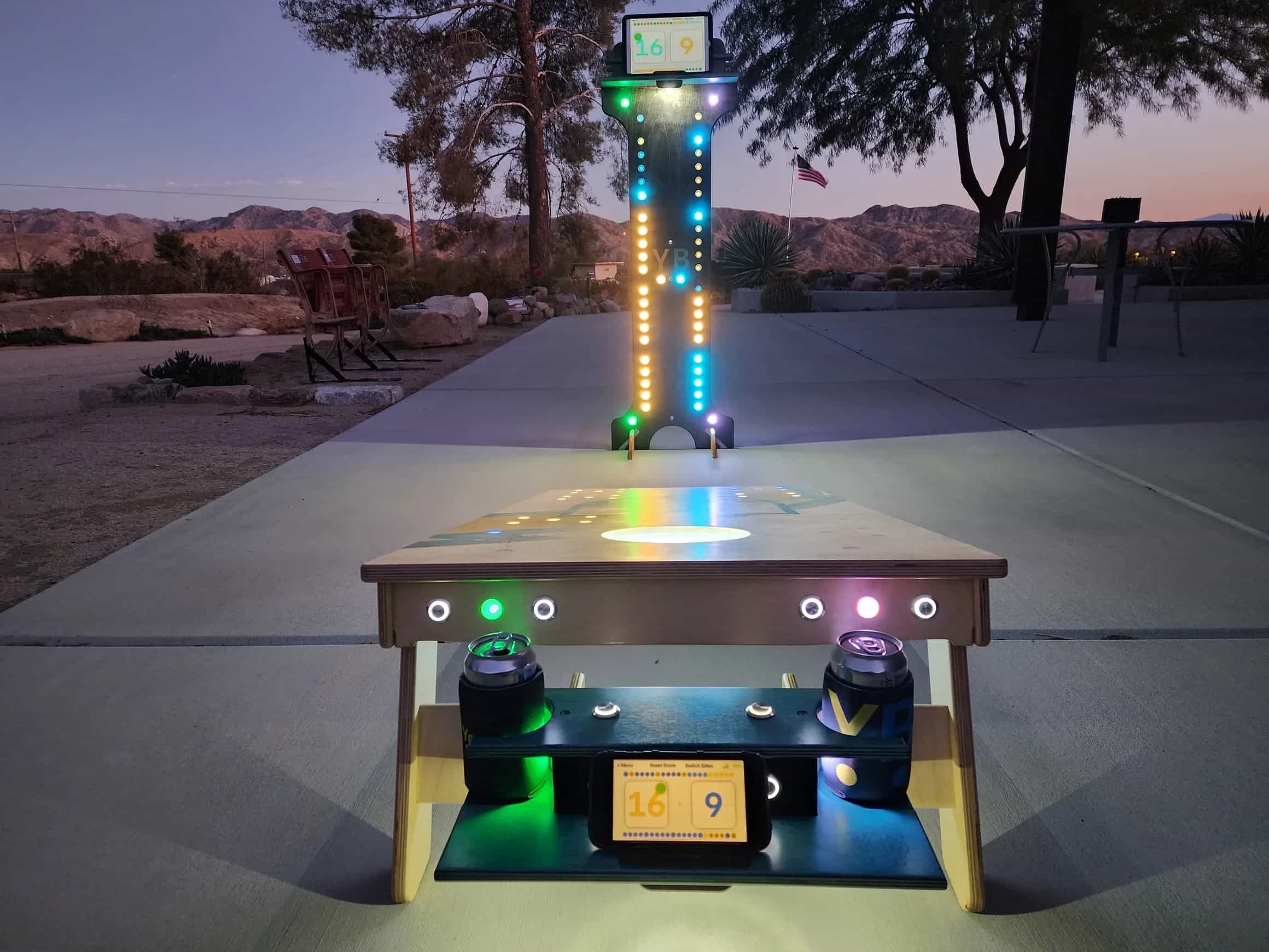 Connected YoreBoard cornhole set showcasing bright Scoring LEDs on the board, a digital scoreboard on an attached scorebox, and a colorful vertical score tower for dynamic play.