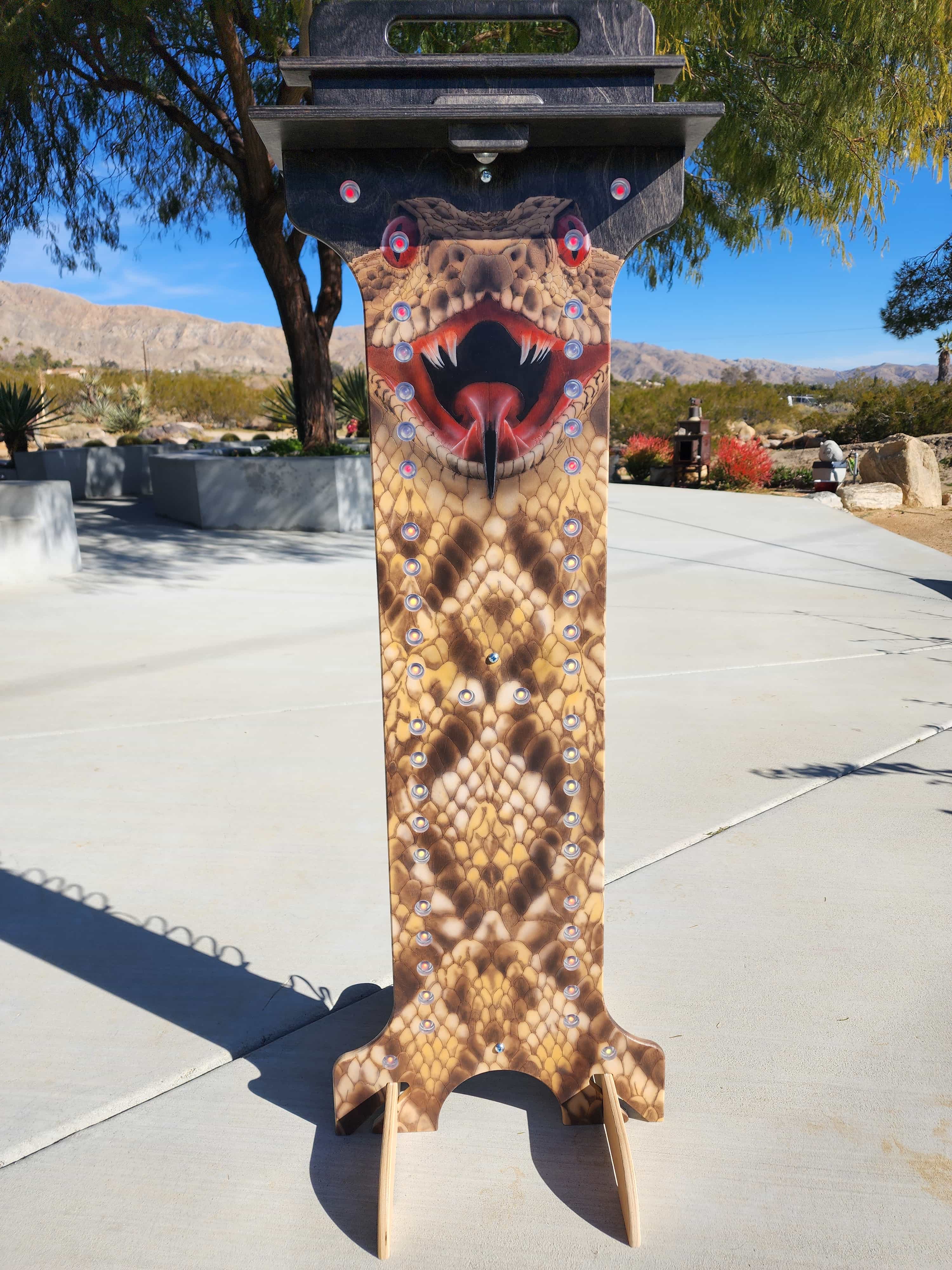 YoreBoard score tower with a highly detailed rattlesnake body and head graphic, featuring integrated Scoring LED holes visible in daylight.